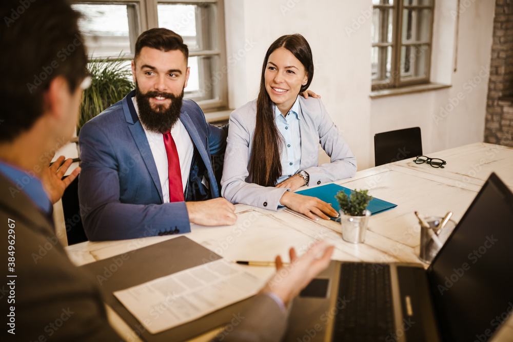 Meeting with agent in office, buying renting apartment or house, buyers of real estate ready to conclude a deal. Meeting with agent in office, buying renting apartment or house, buyers of real estate ready to conclude a deal.