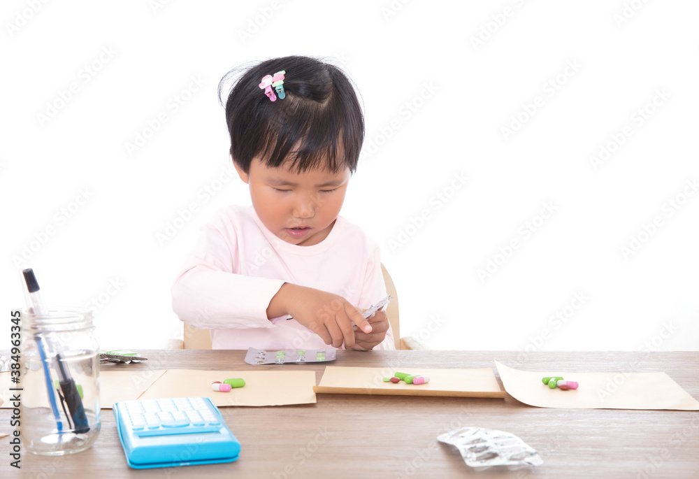 Yellow-skinned child pretends to be a pharmacist dispensing medicine for patients Yellow-skinned child pretends to be a pharmacist dispensing medicine for patients