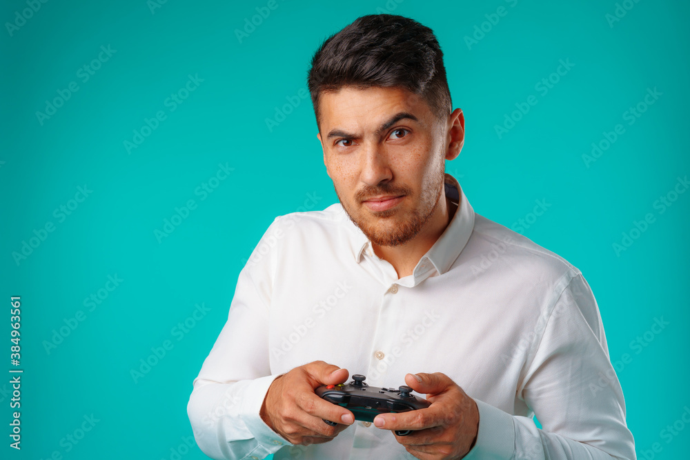 Handsome mixed-race man holding video games joystick Handsome mixed-race man holding video games joystick