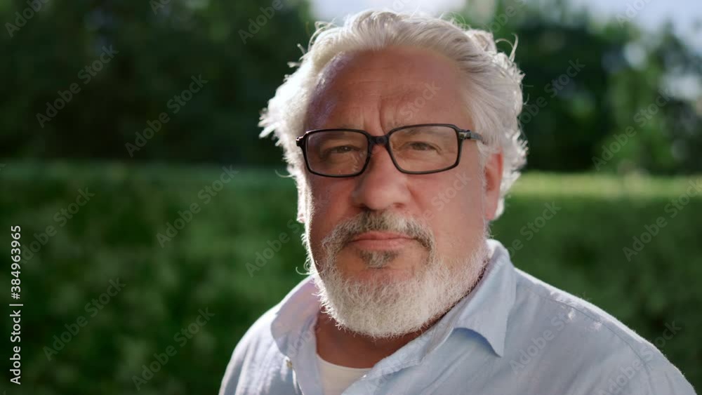 Senior man turning head at camera. Serious male face expression Senior man turning head at camera. Serious male face expression