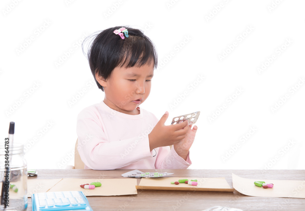 Yellow skin Chinese little girl pretending to be doctor dispensing medicine Yellow skin Chinese little girl pretending to be doctor dispensing medicine