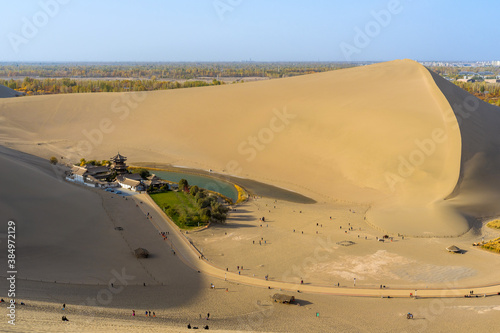 Mingsha shan desert and Crescent moon lake in Dunhuang, Gansu, China. This is a famous place part of the silk road in Dunhuang.