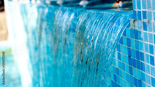 Abstract waterfall background, a swimmingpool with blue mosaic tiles