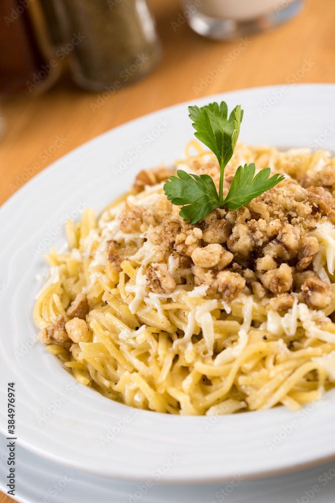 Turkish Noodle / Eriste with cheese, walnuts on wooden background