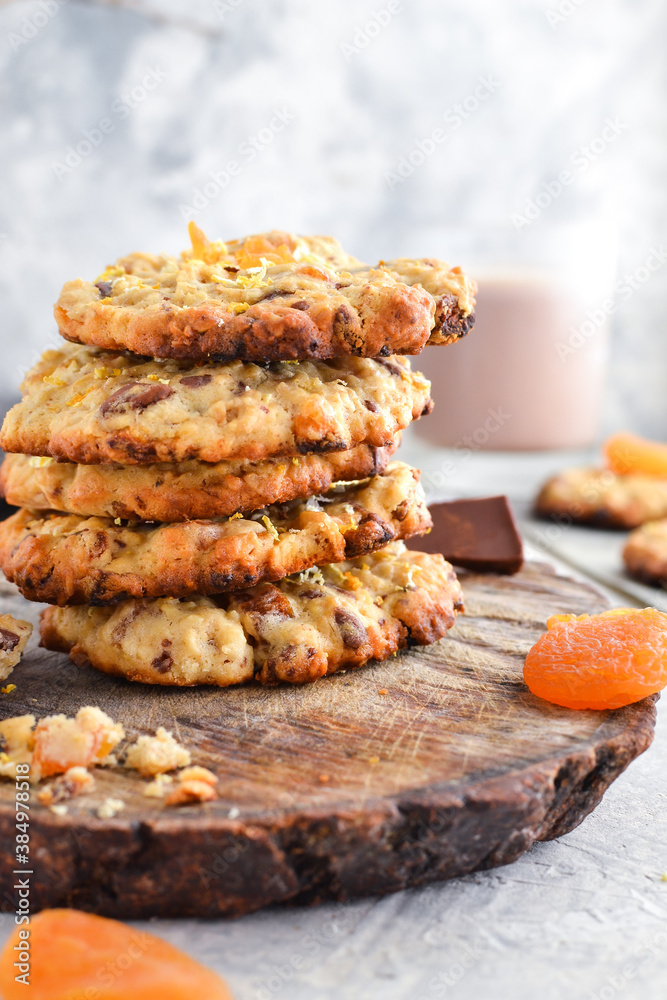 Oatmeal cookies. Homemade baking. Autumn concept of cookies with dried apricots and chocolate. Copy space. Light background. Oatmeal cookies. Homemade baking. Autumn concept of cookies with dried apricots and chocolate. Copy space. Light background.