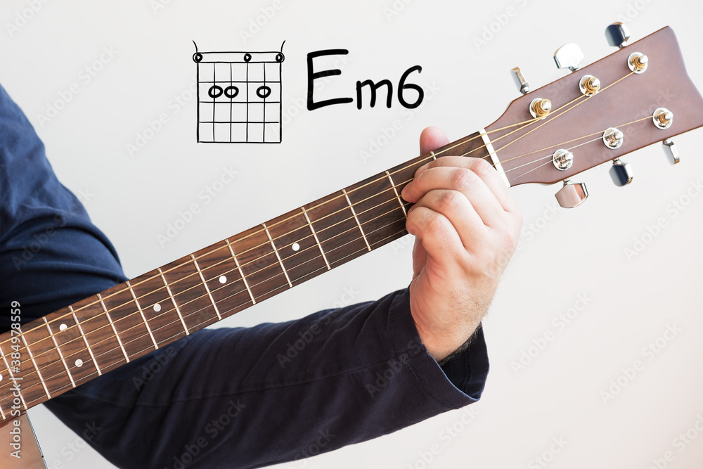 Learn Guitar - Man in a dark blue shirt playing guitar chords displayed on  whiteboard, Chord E Minor 6 Photos | Adobe Stock