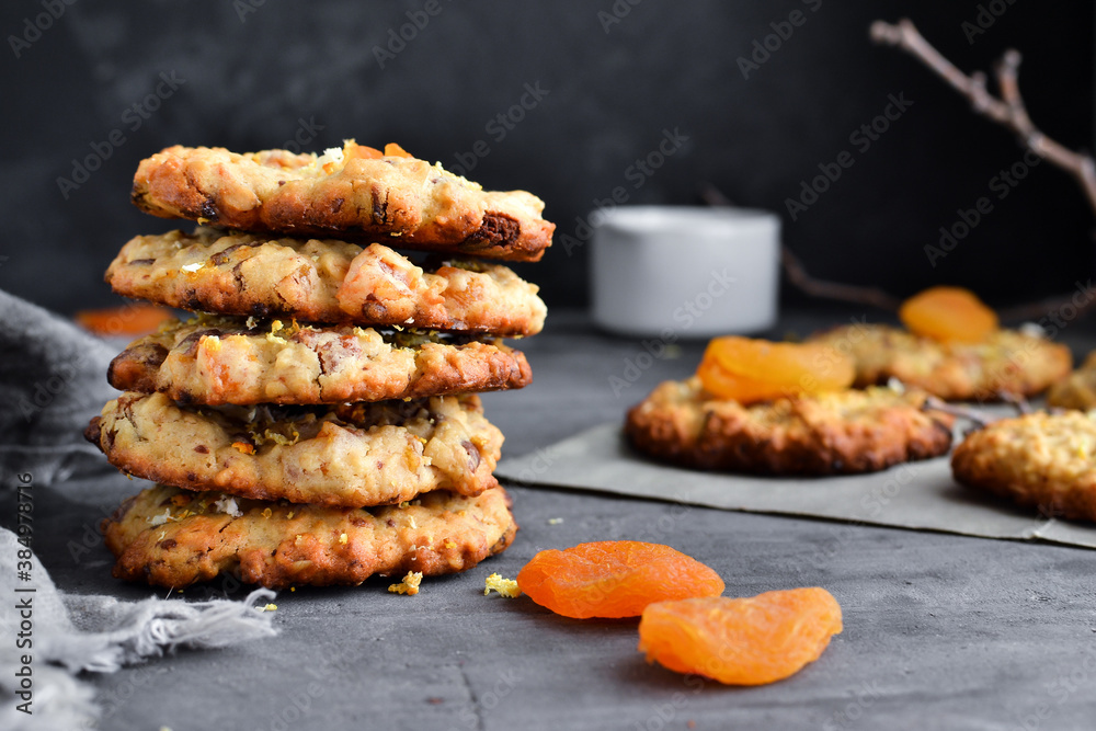 Oatmeal cookies. Homemade baking. Autumn concept of cookies with dried apricots and chocolate. Copy space. Dark background. Oatmeal cookies. Homemade baking. Autumn concept of cookies with dried apricots and chocolate. Copy space. Dark background.
