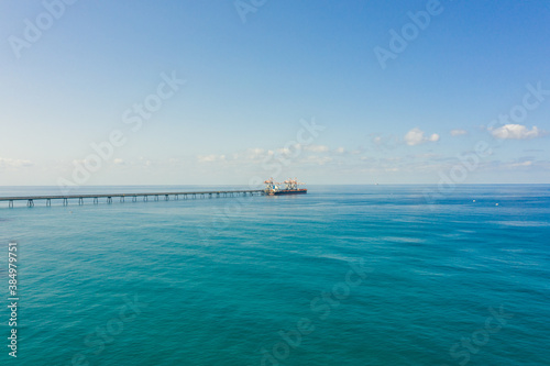 Coal carrier Cargo Ship docked at a commercial pier during unloading operation  Aerial view.