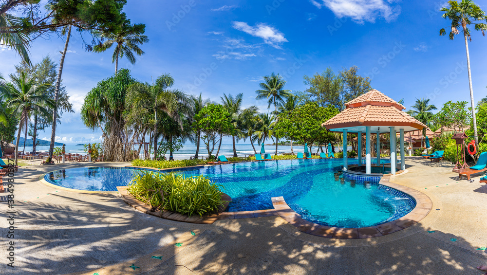 Panorama of Pool with coconut trees and beautiful beach as background at Koh Chang, Trat, Thailand.