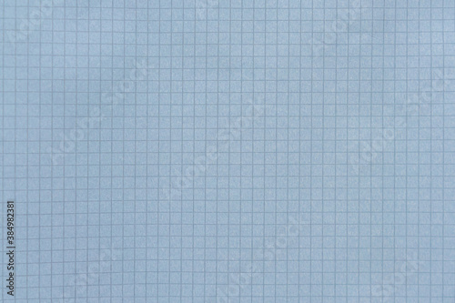 Blue checkered paper sheet as a background.