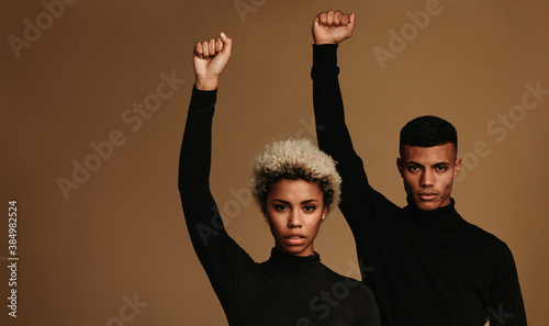 Photographie African american couple standing with raised fist