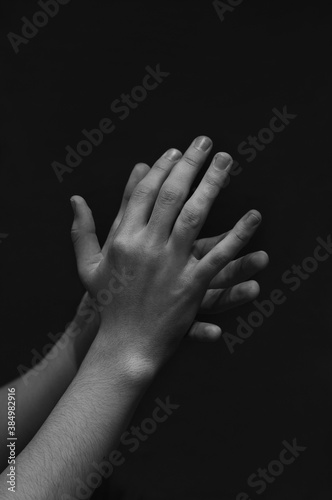 men's hands on a dark background close-up