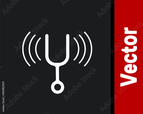 White Musical tuning fork for tuning musical instruments icon isolated on black background. Vector.