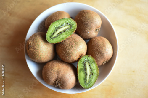 Fresh Whole and Cutted Kiwi in the Plate