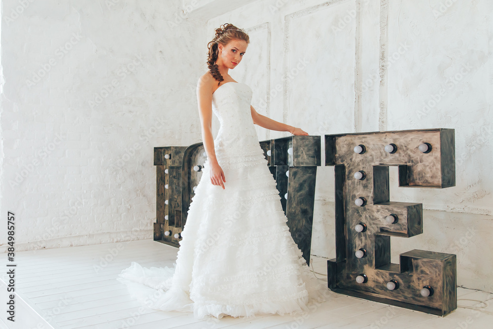 Wedding day and beautiful bride in studio. Beautiful young bride with wedding makeup and hairstyle. Portrait of young gorgeous bride. Wedding. Wedding day and beautiful bride in studio. Beautiful young bride with wedding makeup and hairstyle. Portrait of young gorgeous bride. Wedding.