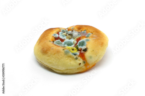 Moldy pizza isolated on white background.