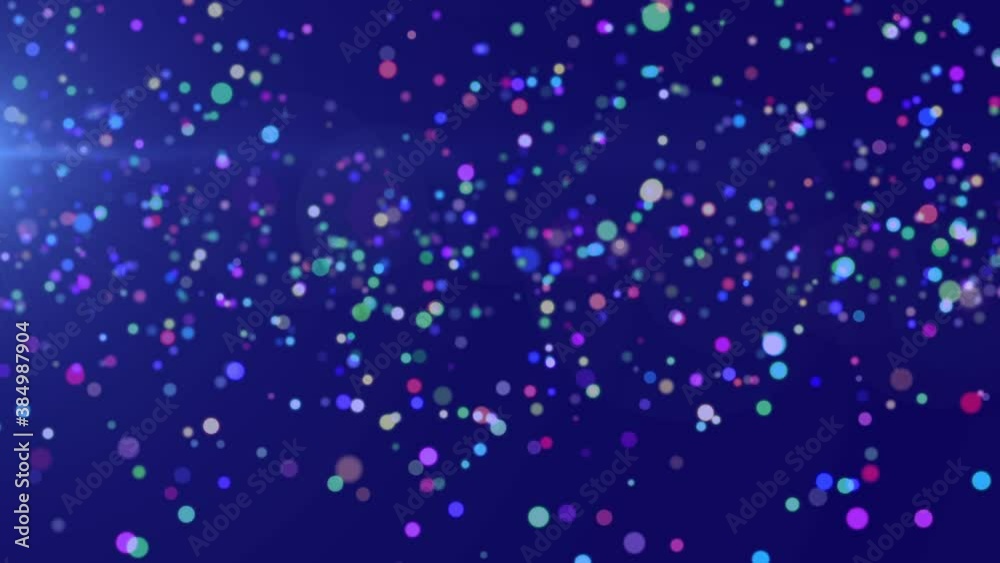Multicolored spots of light moving against blue background