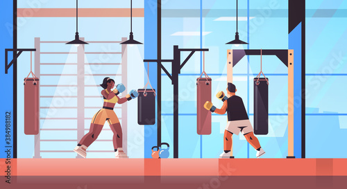 mix race boxers doing exercises with punching bag training healthy lifestyle boxing concept modern fight club interior horizontal full length vector illustration