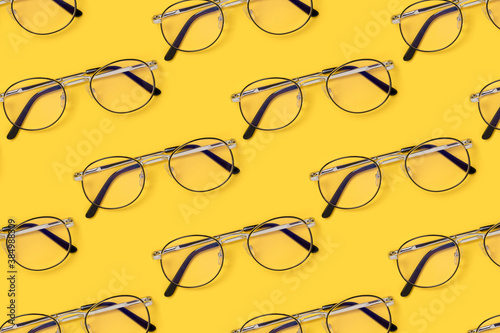 Eyeglasses pattern on a yellow background. Creative layout.