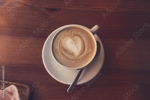 A Cup of coffee, a heart made of coffee foam.