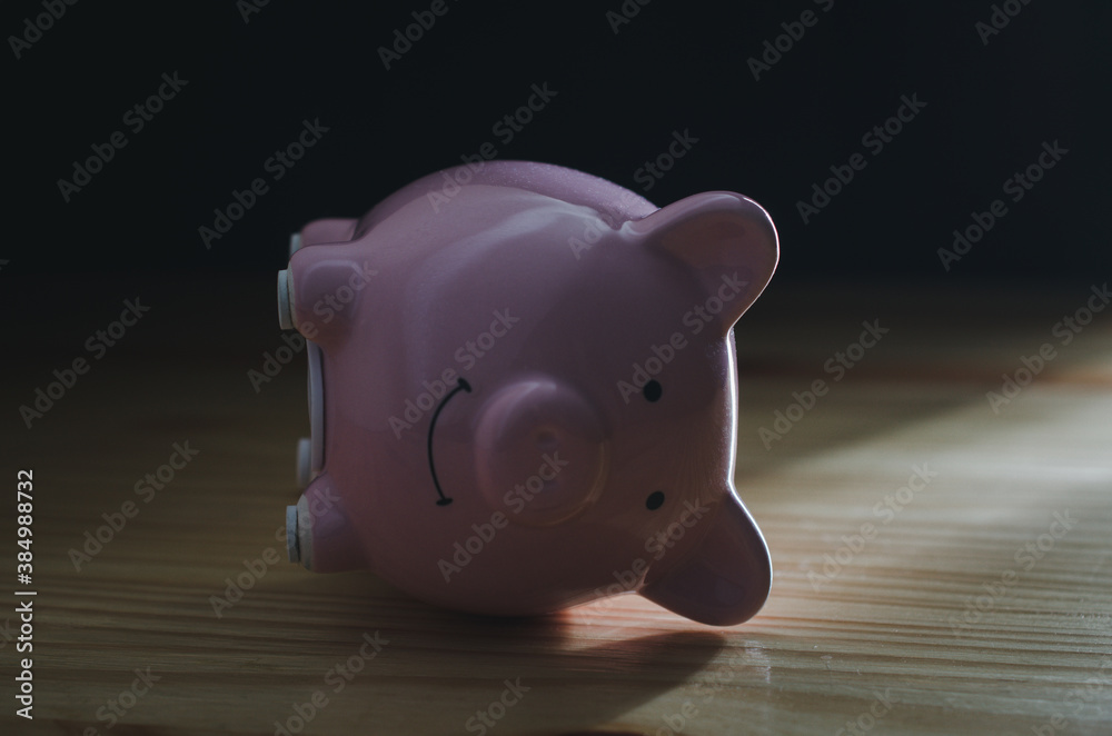 Fototapeta premium Piggy Bank on wood table.money saving financial concept.