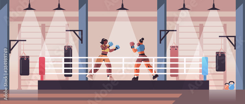mix race female boxers fighting on boxing ring dangerous sport competition training concept modern fight club interior horizontal full length vector illustration