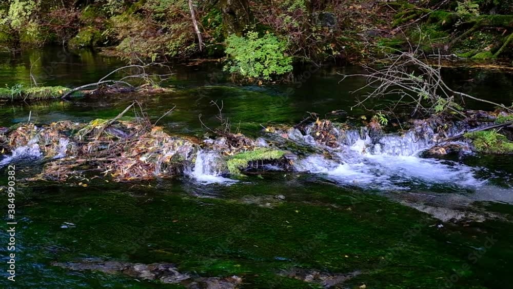 A slow motion of running river at Kamikochi National Park, Japan Alps. A slow motion of running river at Kamikochi National Park, Japan Alps.