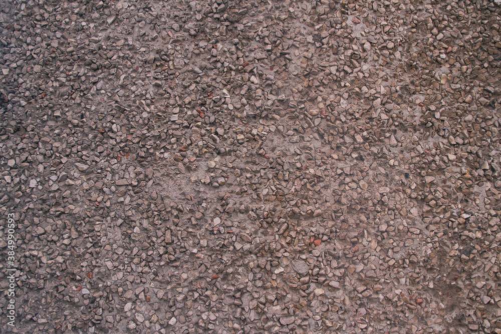 Background of small stones, gravel on the cement. Stone brown background. Background of small stones, gravel on the cement. Stone brown background.