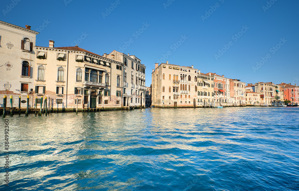 Historic houses with reflections in water of Grand Canal in Venice, Italy