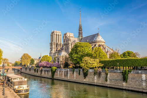 Paris, Notre Dame cathedral with boats on Seine in France