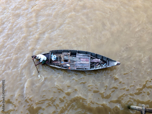 a fisherman paddling his boat in the river