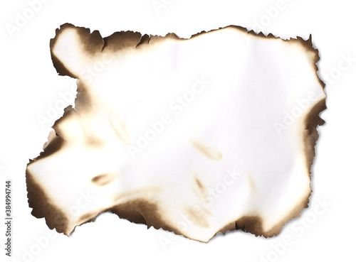 Burned and charred paper scrap, parchment isolated on white background, top view