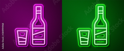 Glowing neon line Bottle of vodka with glass icon isolated on purple and green background. Vector.