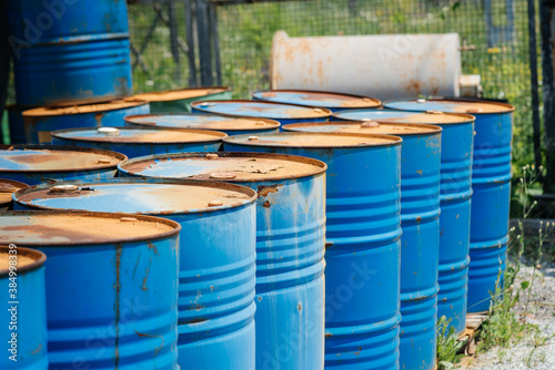 Big oil drums, blue. Chemical barrels in an open warehouse. Rusty barrels. Barrel for oil