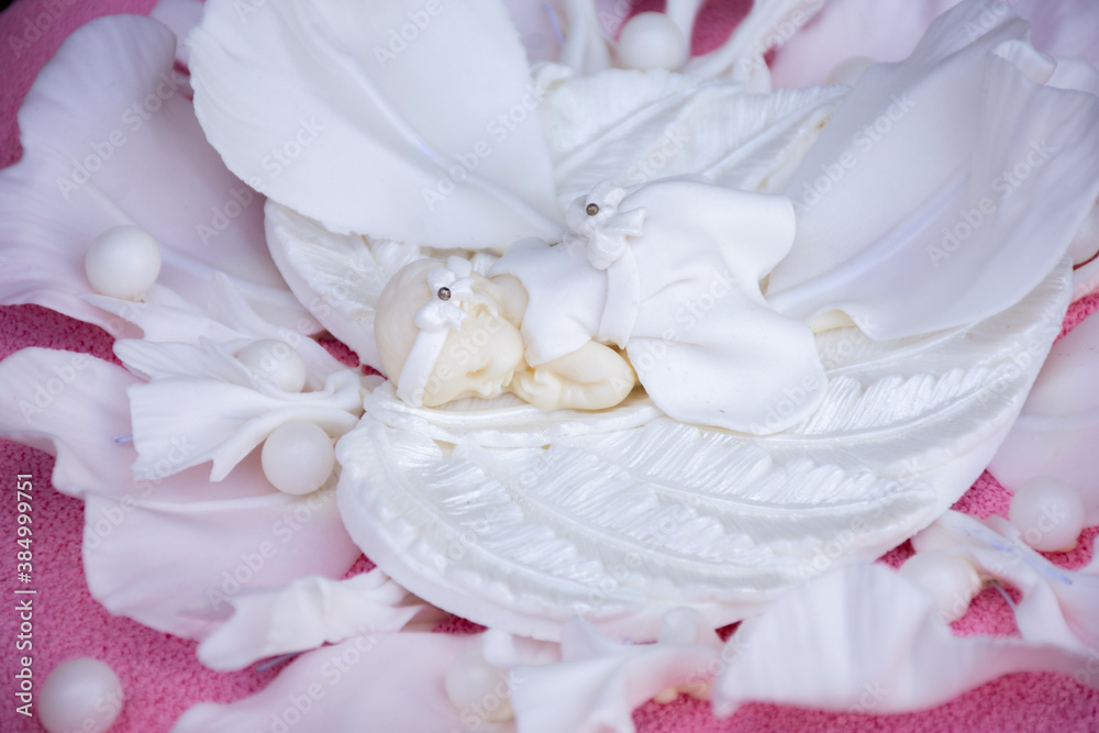 sculpture of an angel on a white flower. cake decoration