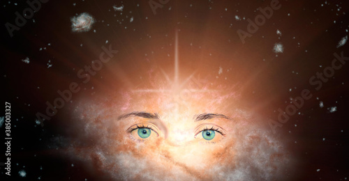 The concept of clairvoyance. Piercing green eyes looking into the future against the background of the galaxy. Paranormal abilities, clairvoyance, divination. Elements of this image are provided by NA photo