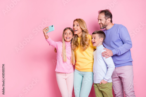 Photo of positive dream small girl take selfie dad mom brother on smartphone isolated over pastel color background