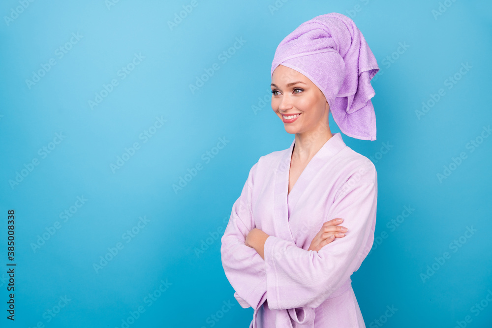 Profile photo of lovely young woman crossed arms look empty space wear purple towel turban bathrobe isolated blue color background Profile photo of lovely young woman crossed arms look empty space wear purple towel turban bathrobe isolated blue color background