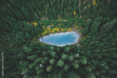 Aero shooting of crystal clear mountain. Lake Rosohan. Emerald trees and turquoise lake water. Ukrainian Carpathian Mountains photo