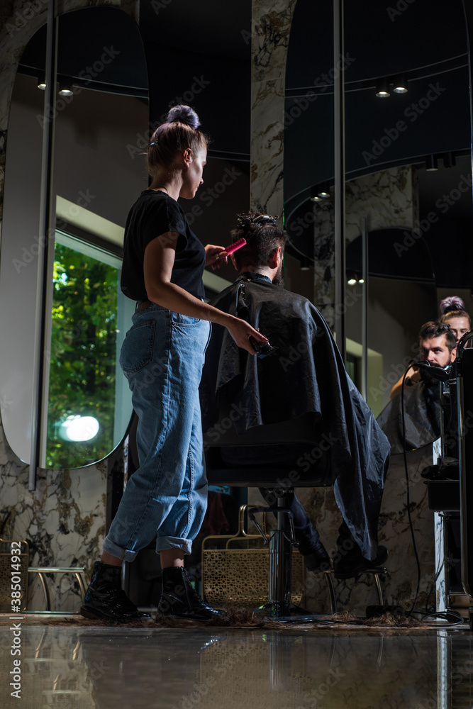 brutal guy with barbershop professional master use electric shaver. Bearded and stylish. male barber care. bearded man at hairdresser chair in salon. beauty and fashion. hair and beard styling