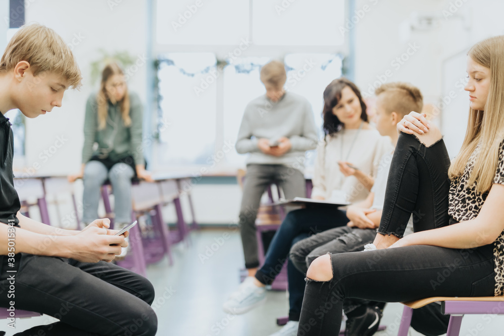 Children sit on tables during extracurricular activities at school