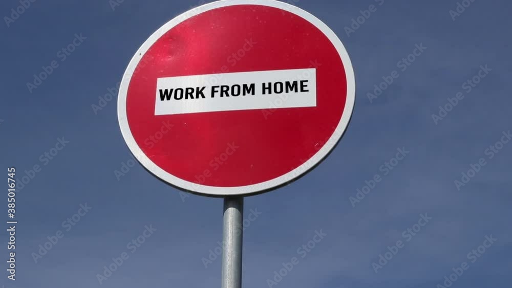 red road sign no entry with text work from home against the blue sky background. Coronavirus control concept red road sign no entry with text work from home against the blue sky background. Coronavirus control concept