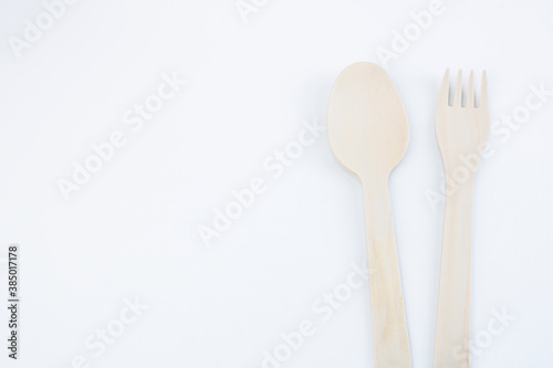 eco friendly disposable kitchen utensils on a white background. wooden fork, spoon. Ecology, zero waste concept. View from above. Flat lay.