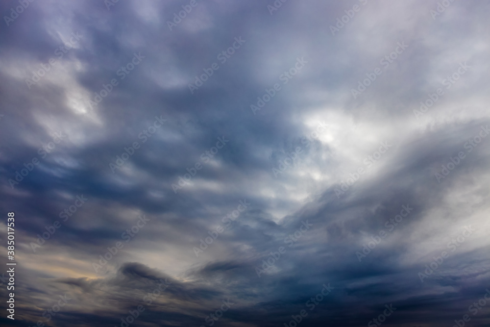 Abstract background with blue clouds in the evening in the atmosphere. A storm is on the horizon.