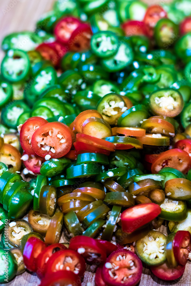 Pile of colourful ripe jalapenos cuts ready for cooking and preservation. Pile of colourful ripe jalapenos cuts ready for cooking and preservation.