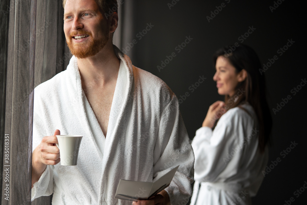 Handsome, muscular, young man drinking his morning coffee in a hotel room Handsome, muscular, young man drinking his morning coffee in a hotel room