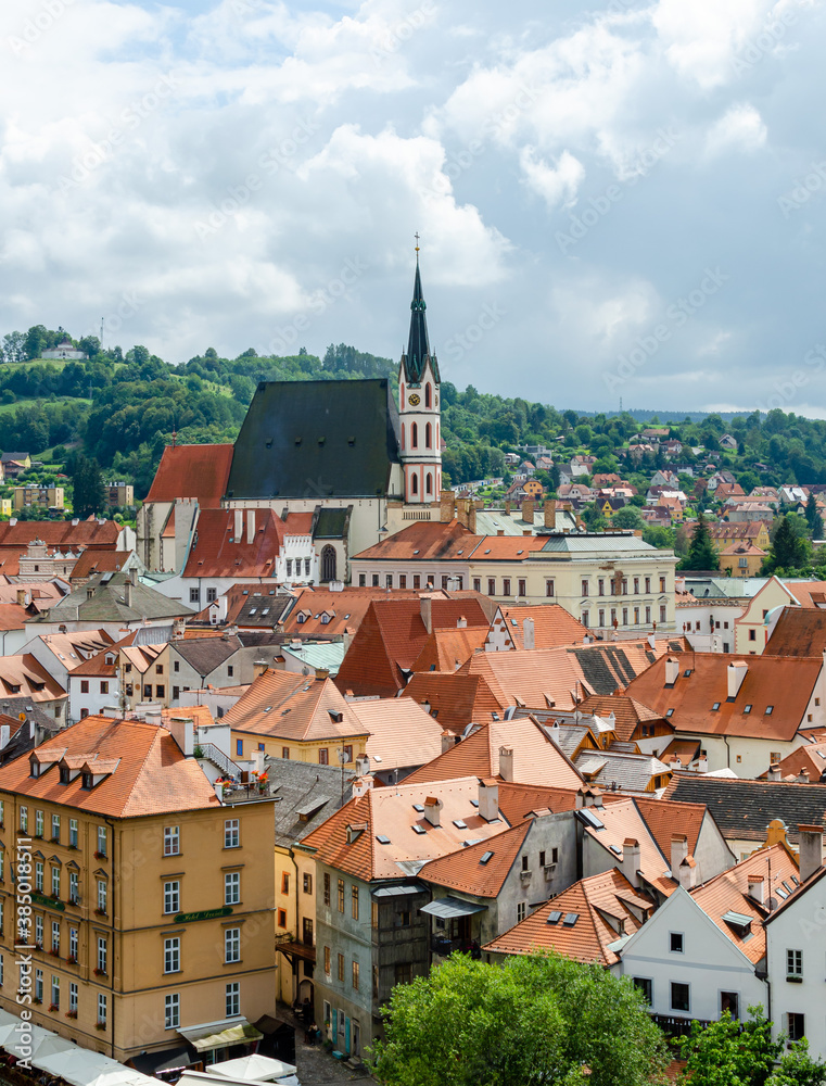 Vertical Rooftop view of Cesky Krumlov and high St Vitus church, famous touristic old town in Czech Republic in summer. Vertical Rooftop view of Cesky Krumlov and high St Vitus church, famous touristic old town in Czech Republic in summer.