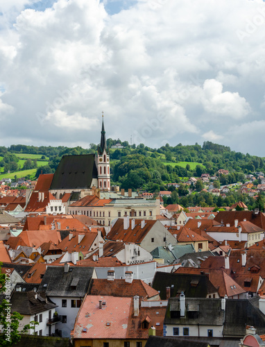 Vertical Rooftop view of Cesky Krumlov and high St Vitus church, famous touristic old town in Czech Republic in summer.