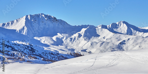 Panoramic view of the snowy high-altitude mountain range near the Tignes ski resort in France during the winter season.