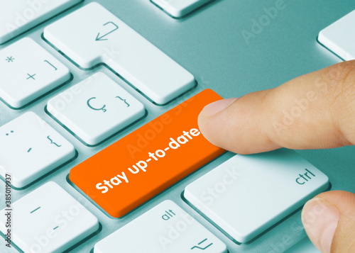 Stay up-to-date - Inscription on Orange Keyboard Key.